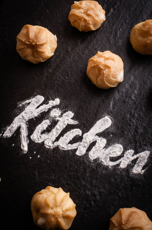 Kitchen text with group of eclair on black backgroundの写真素材