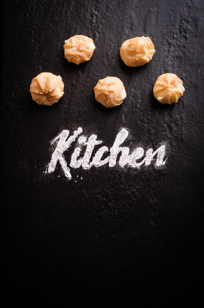 Kitchen text with group of eclair on black backgroundの写真素材
