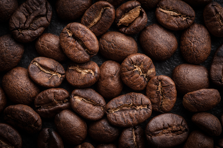 roasted coffee beans on dark background, can be used as a backgroundの写真素材
