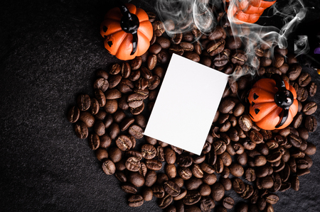 Halloween pumpkin decoration with coffee beans on dark backgroundの写真素材