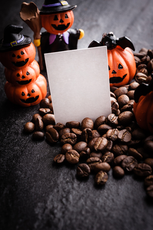 Halloween pumpkin decoration with coffee beans on dark backgroundの写真素材