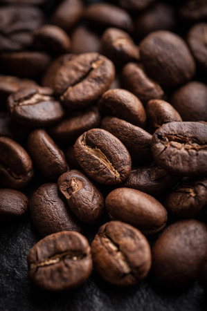 roasted coffee beans on dark background, can be used as a backgroundの写真素材