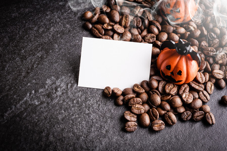 Halloween pumpkin decoration with coffee beans on dark backgroundの写真素材