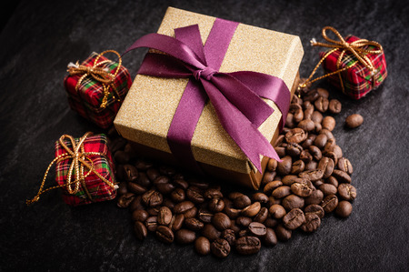 roasted coffee beans with black paper on wooden background, can be used as a backgroundの写真素材