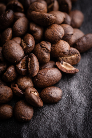 roasted coffee beans on dark background, can be used as a backgroundの写真素材