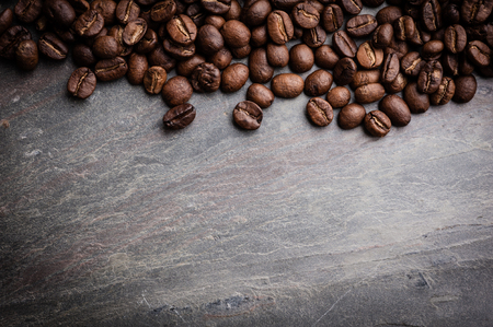 Coffee beans on grunge stone backgroundの写真素材