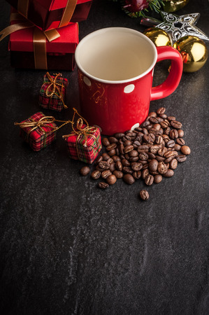 Red mug and Christmas tree with decoration on dark stone backgroundの写真素材