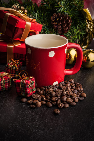 Red mug and Christmas tree with decoration on dark stone backgroundの写真素材