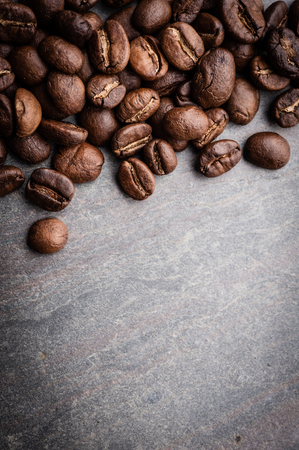 Coffee beans on grunge stone backgroundの写真素材