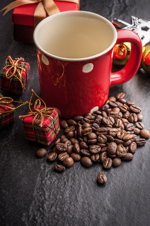 Red mug and Christmas tree with decoration on dark stone backgroundの写真素材