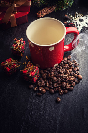 Red mug and Christmas tree with decoration on dark stone backgroundの写真素材
