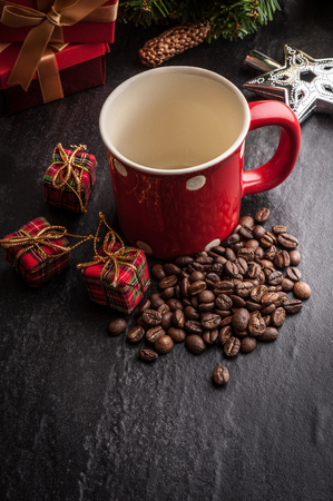 Red mug and Christmas tree with decoration on dark stone backgroundの写真素材