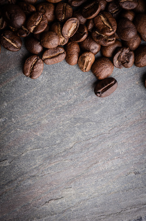 Coffee beans on grunge stone backgroundの写真素材