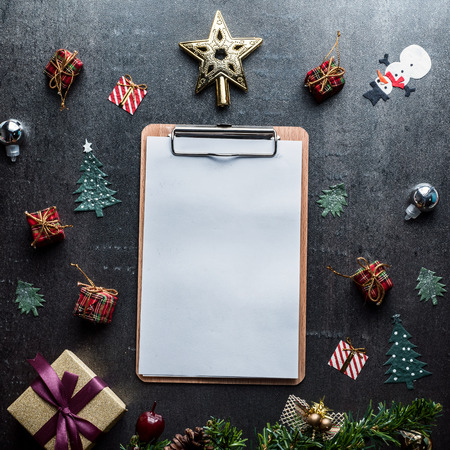 Blank clipboard and Christmas decoration on dark stone backgroundの写真素材