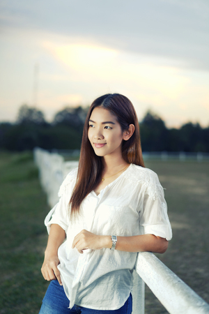woman in a farm at sunset stroll and relax , breathe fresh air outdoors.Concept Refresh and beautyの写真素材