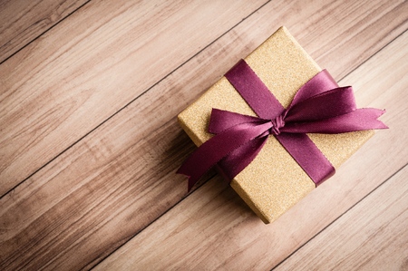 Gift box laid on a wooden table backgroundの写真素材