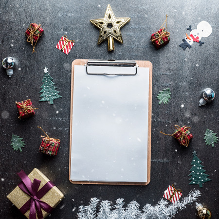 Blank clipboard and Christmas decoration on dark stone backgroundの写真素材