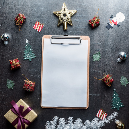 Blank clipboard and Christmas decoration on dark stone backgroundの写真素材