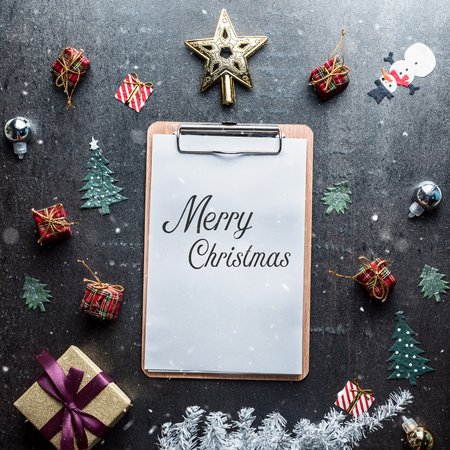 Blank clipboard and Christmas decoration on dark stone backgroundの写真素材