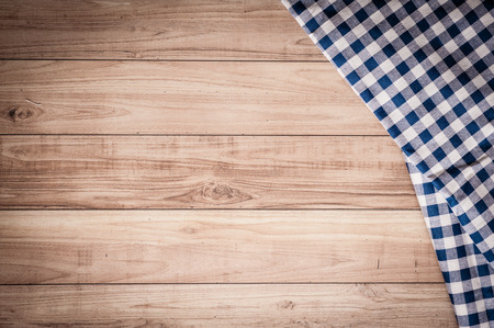 the checkered tablecloth on wooden background. Use for background.の写真素材
