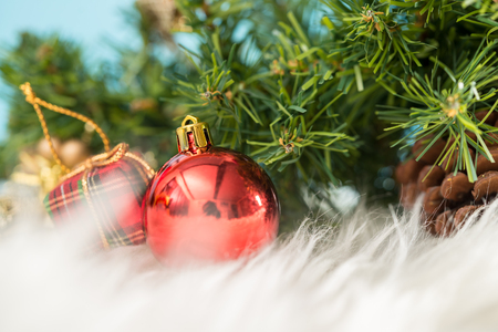 Christmas background with a red ornament gift box and fir in snow. Merry christmas and happy new year greeting card with copy-space. Christmas celebration holiday background.の写真素材