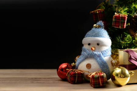Happy snowman standing in dark winter christmas snow background. Merry christmas and happy new year greeting card with copy-space. Christmas celebration holiday background.の写真素材
