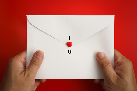 I LOVE YOU. Valentine's hearts on white envelope background with copy space. Symbol of love. Happy Valentines Day background concept.の写真素材