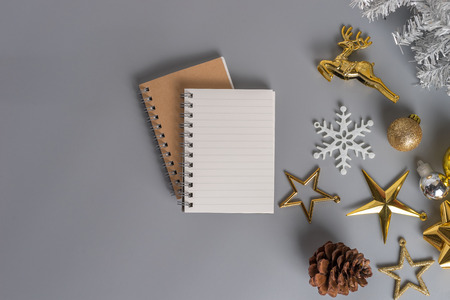 Flat view of blank notepads with gold ornaments and christmas decorations. Merry christmas and happy new year greeting card with copy space. Christmas celebration holiday background.の写真素材