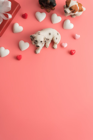 Flat view of valentines hearts with dog and decoration on pink background with copy space.の写真素材