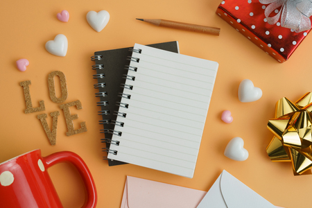 Flat view of blank notepads with valentines hearts and decoration on color background with copy space.の写真素材