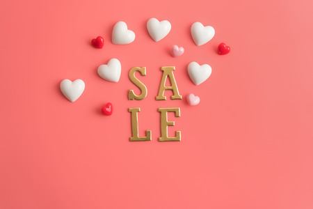 Flat view of SALE alphabet in the centre of valentines hearts and decoration on pink color background with copy space. Symbol of love. Happy Valentines Day background.の写真素材
