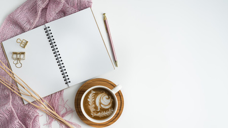 Styled stock photography white office desk table with blank notebook, computer, supplies and coffee cup. Top view with copy space. Flat lay.の写真素材