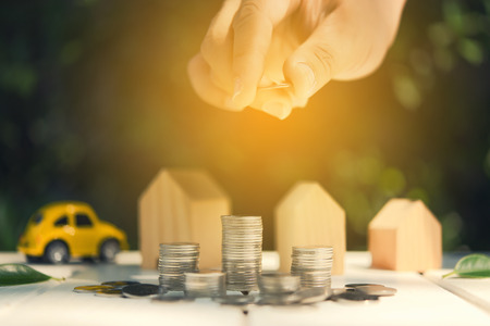 Saving to buy a house or car savings concept with money coin stack growing.Saving money concept.の写真素材