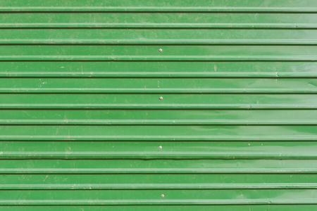 Background of a old green metal wall or container horizontal.Green shipping container stripe pattern.の写真素材
