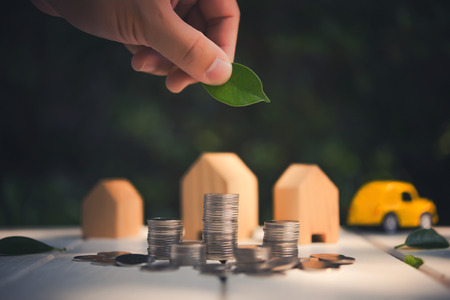 Saving to buy a house or home savings concept with money coin stack growing. Saving money concept.の写真素材
