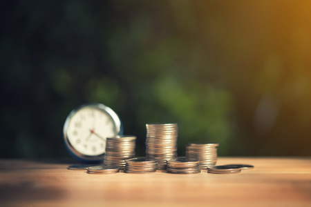 Savings concept with money coin stack growing. Time saving money concept.の写真素材