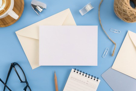 A wedding mock up concept. Wedding Invitation, envelopes, cards Papers on light blue background with ribbon and decoration. Top view, flat lay, copy spaceの写真素材