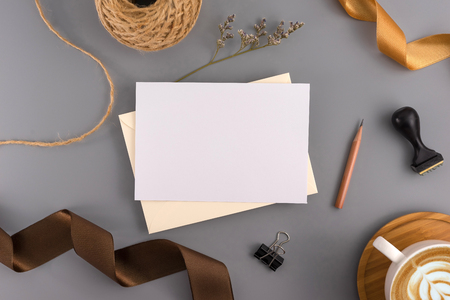 A wedding concept. Wedding Invitation, envelopes, cards Papers on grey background with ribbon and decoration. Top view, flat lay, copy spaceの写真素材
