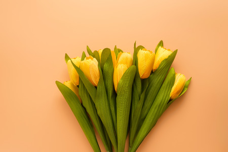 Flat lay, top view yellow flowers on brown color background with copyspace. Selective focus. Place for text.の写真素材
