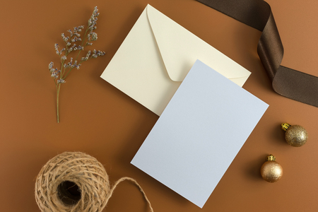 A wedding concept. Wedding Invitation, envelopes, cards Papers on brown background with ribbon and decoration. Top view, flat lay, copy spaceの写真素材