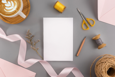 A wedding mock up concept. Wedding Invitation, envelopes, cards Papers on grey background with ribbon and decoration. Top view, flat lay, copy spaceの写真素材