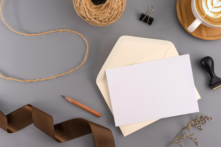 A wedding concept. Wedding Invitation, envelopes, cards Papers on grey background with ribbon and decoration. Top view, flat lay, copy spaceの写真素材