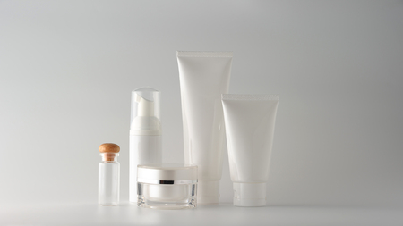 Set of cosmetic products on a color background. Cosmetic package collection for cream, soups, foams, shampoo.Natural beauty blank label for branding mock-up concept.の写真素材