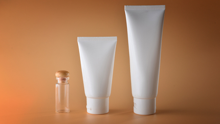Set of cosmetic products on a color background. Cosmetic package collection for cream, soups, foams, shampoo.Natural beauty blank label for branding mock-up concept.の写真素材