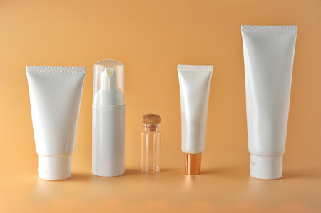 Set of cosmetic products on a color background. Cosmetic package collection for cream, soups, foams, shampoo.Natural beauty blank label for branding mock-up concept.の写真素材