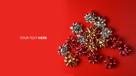 Flat lay, Top view minimal composition background of red decorative Christmas gift bows. New Year and Christmas concept with copyspace.の写真素材