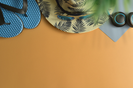 Flat lay, top view workspace with eye glasses, notebook, hat, sun block, shoes and coffee cup on yellow background. Summer stylish traveller blogger concept.の写真素材
