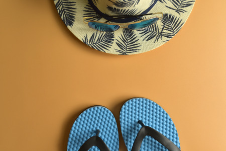 Flat lay, top view workspace with eye glasses, notebook, hat, sun block, shoes and coffee cup on yellow background. Summer stylish traveller blogger concept.の写真素材