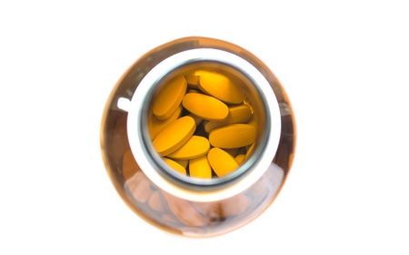 Yellow pills in the brown bottleの写真素材