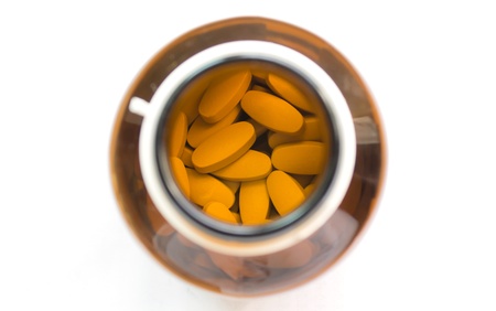 Yellow pills in the brown bottleの写真素材